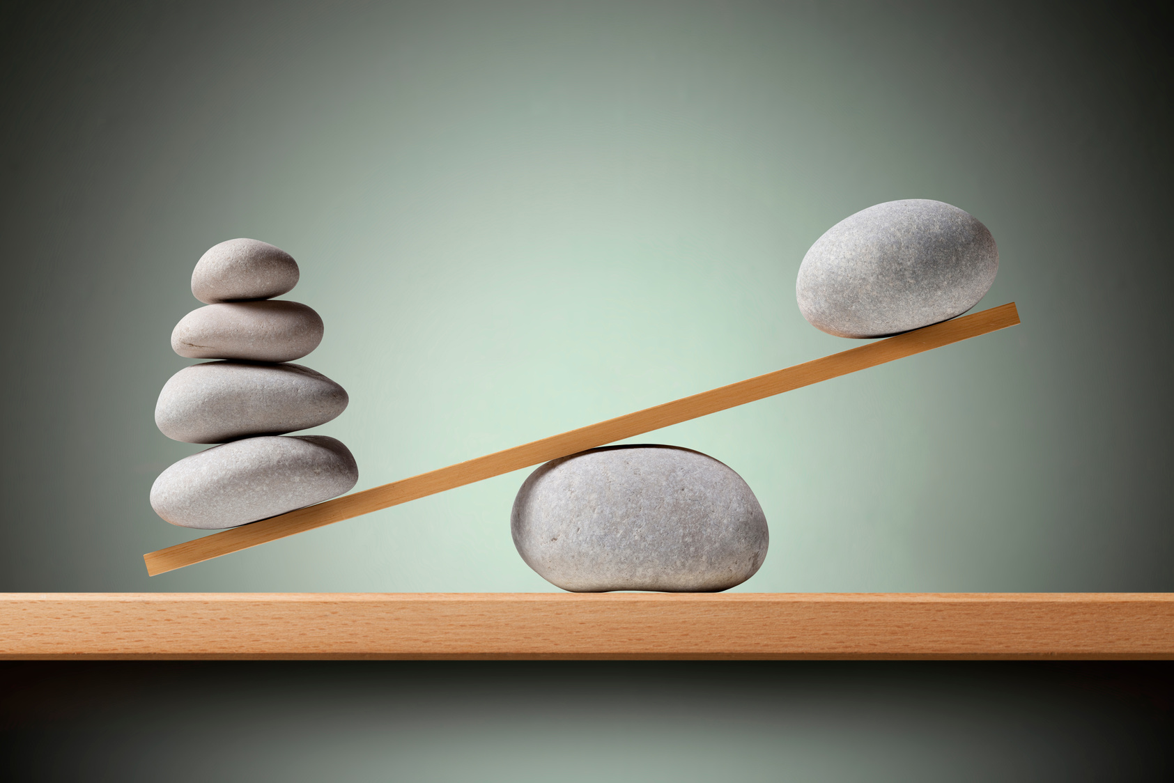 Imbalance. Balancing stones on the shelf.